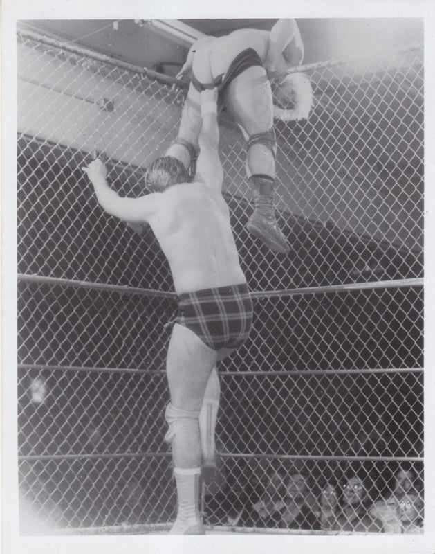 1980's Portland Wrestling "Rowdy" Roddy Piper vs. Playboy Buddy Rose (cage) vintage Promo Photo PWcatalog