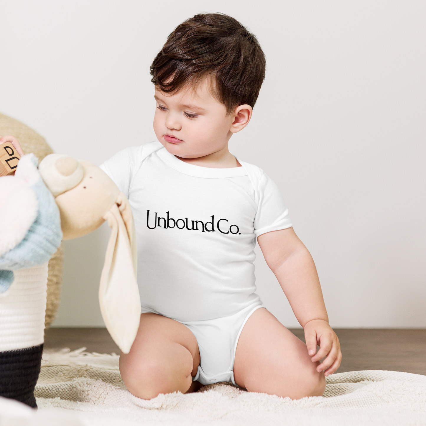 Unbound Co. Baby short sleeve one piece (Wordlogo) PW Catalog